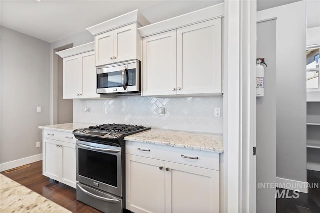 3631 S Pheasant Tail Way, Boise, ID 83716 - kitchen featuring appliances with stainless steel finishes, baseboards, dark wood-type flooring, backsplash, and light stone countertops