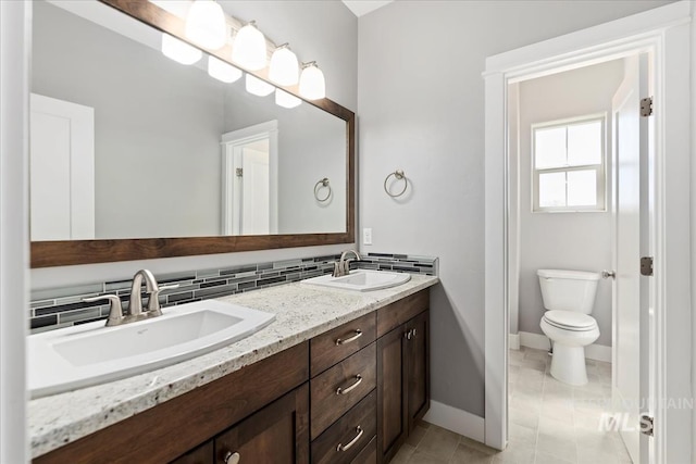 3631 S Pheasant Tail Way, Boise, ID 83716 - full bathroom with double vanity, baseboards, toilet, and tile patterned flooring