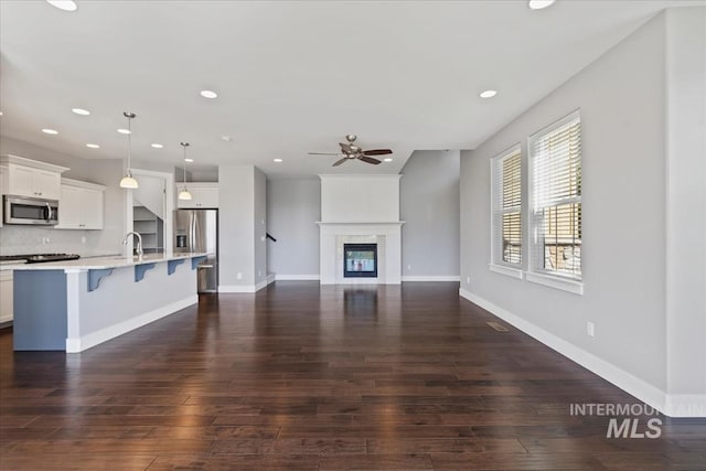 3631 S Pheasant Tail Way, Boise, ID 83716 - unfurnished living room featuring ceiling fan, dark wood-type flooring, recessed lighting, and a large fireplace