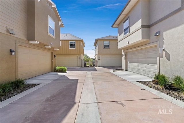 3631 S Pheasant Tail Way, Boise, ID 83716 - view of side of home featuring stucco siding, an attached garage, and concrete driveway
