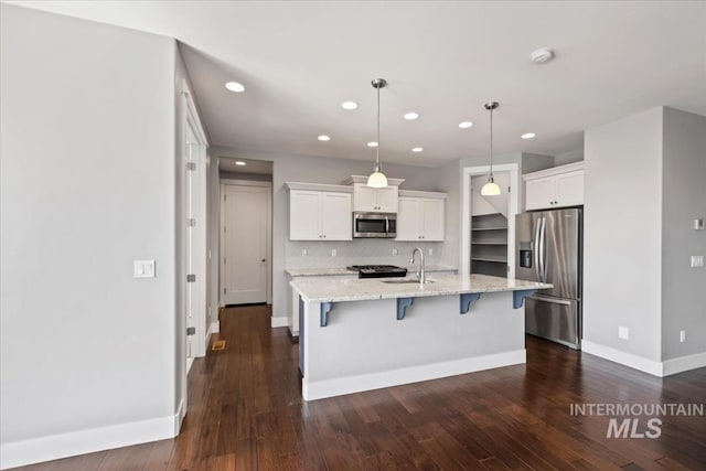 3631 S Pheasant Tail Way, Boise, ID 83716 - kitchen with appliances with stainless steel finishes, white cabinets, recessed lighting, a breakfast bar, and dark wood-style flooring
