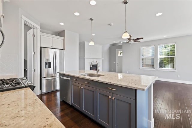 3631 S Pheasant Tail Way, Boise, ID 83716 - kitchen featuring appliances with stainless steel finishes, a sink, dark wood-style flooring, recessed lighting, and light stone counters