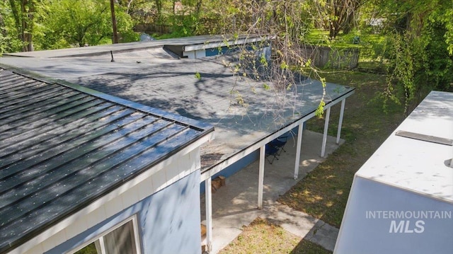 exterior space with fence and metal roof