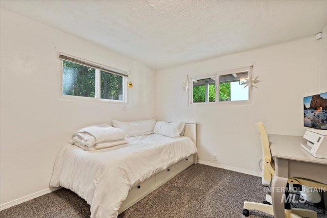 bedroom with baseboards and carpet