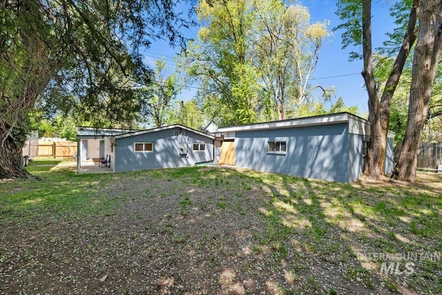 back of house featuring a patio and fence