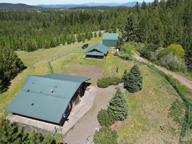 view from above of property featuring a heavily wooded area and mountains