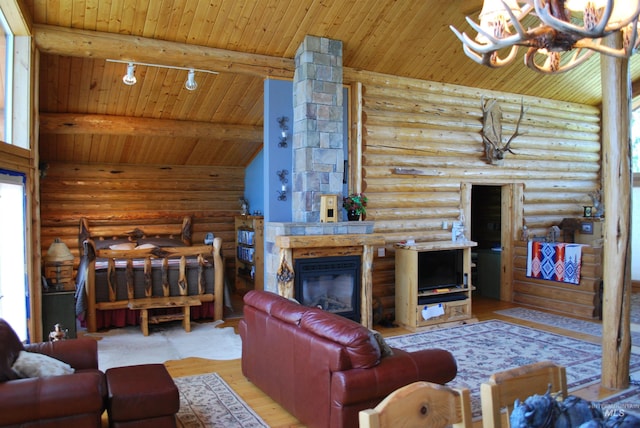 living area featuring wood ceiling, rustic walls, wood finished floors, a glass covered fireplace, and a chandelier