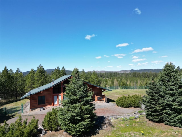 aerial view of property and surrounding area featuring a forest