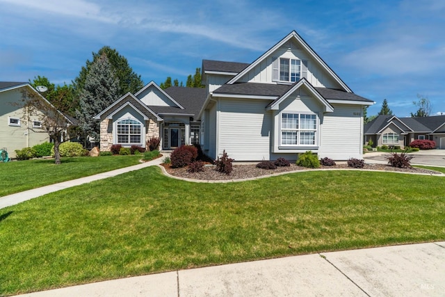 view of front of property with a front lawn, board and batten siding, and roof with shingles