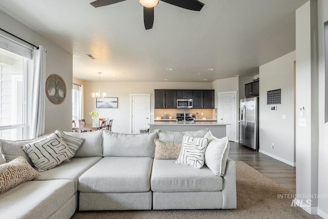 8228 S Bogus Ridge Ave, Boise, ID 83716 - living room with a chandelier, ceiling fan, baseboards, dark wood finished floors, and recessed lighting