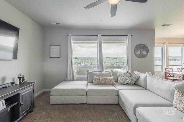 8228 S Bogus Ridge Ave, Boise, ID 83716 - living room featuring dark colored carpet, a ceiling fan, and baseboards