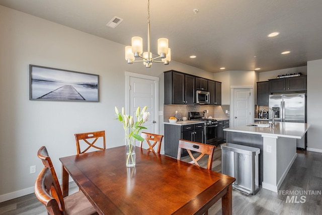 8228 S Bogus Ridge Ave, Boise, ID 83716 - dining space with a chandelier, baseboards, dark wood finished floors, and recessed lighting