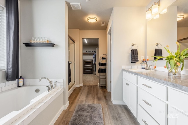 8228 S Bogus Ridge Ave, Boise, ID 83716 - full bathroom with vanity, a stall shower, and wood finished floors