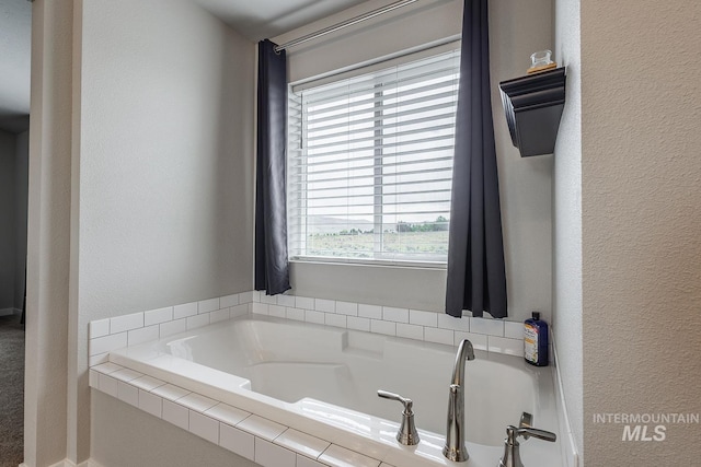 8228 S Bogus Ridge Ave, Boise, ID 83716 - bathroom featuring a garden tub and a textured wall
