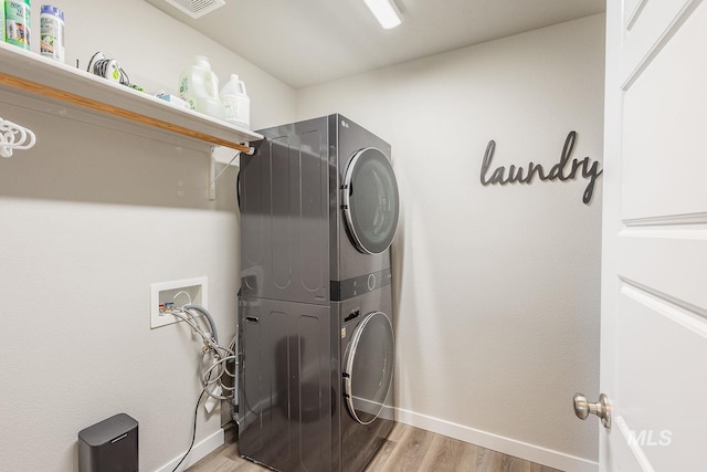 8228 S Bogus Ridge Ave, Boise, ID 83716 - washroom with stacked washer / dryer, light wood-style flooring, and baseboards