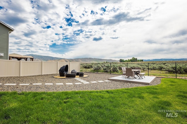 8228 S Bogus Ridge Ave, Boise, ID 83716 - view of yard featuring a mountain view, an outdoor fire pit, and a patio