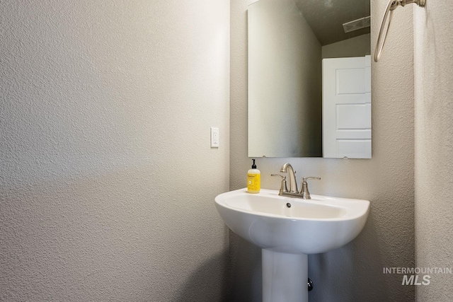 8228 S Bogus Ridge Ave, Boise, ID 83716 - bathroom featuring a textured wall and a sink