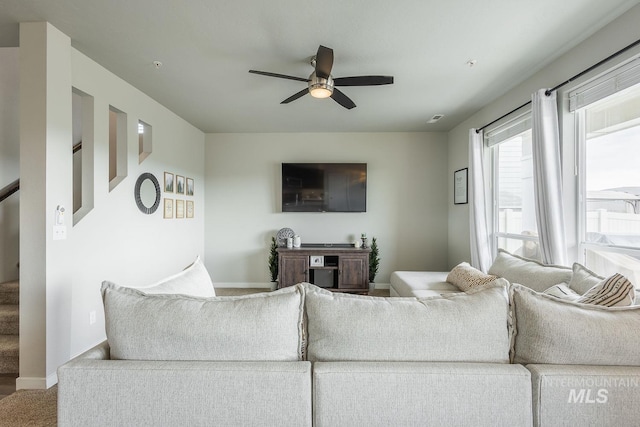 8228 S Bogus Ridge Ave, Boise, ID 83716 - carpeted living room with a ceiling fan, stairway, and baseboards