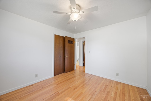 spare room with ceiling fan, baseboards, visible vents, and light wood-style floors