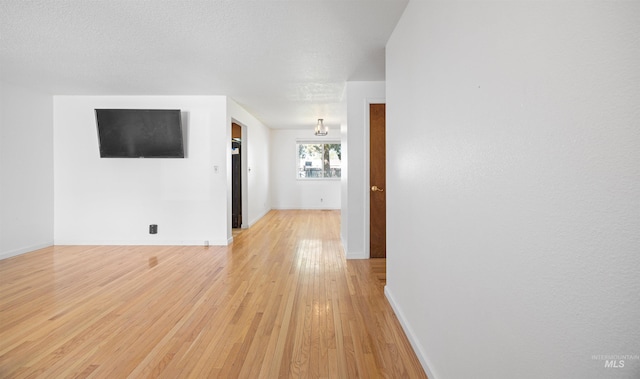 interior space featuring light wood-style flooring and baseboards