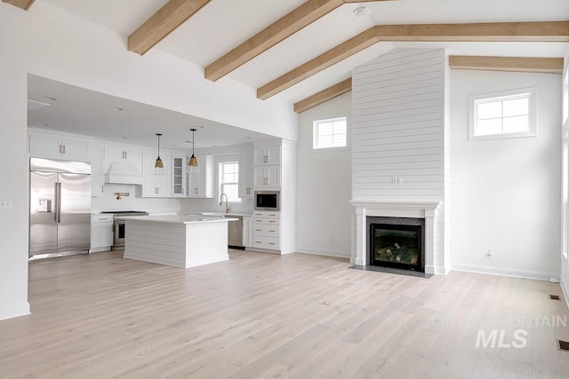7927 W Rockhaven Dr, Eagle, ID 83616 - unfurnished living room with light wood-type flooring and a fireplace with flush hearth