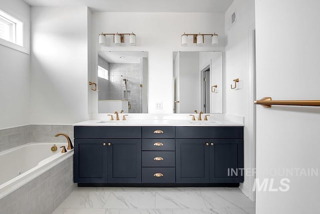 7927 W Rockhaven Dr, Eagle, ID 83616 - bathroom with double vanity, a bath, a shower stall, and marble look tiles