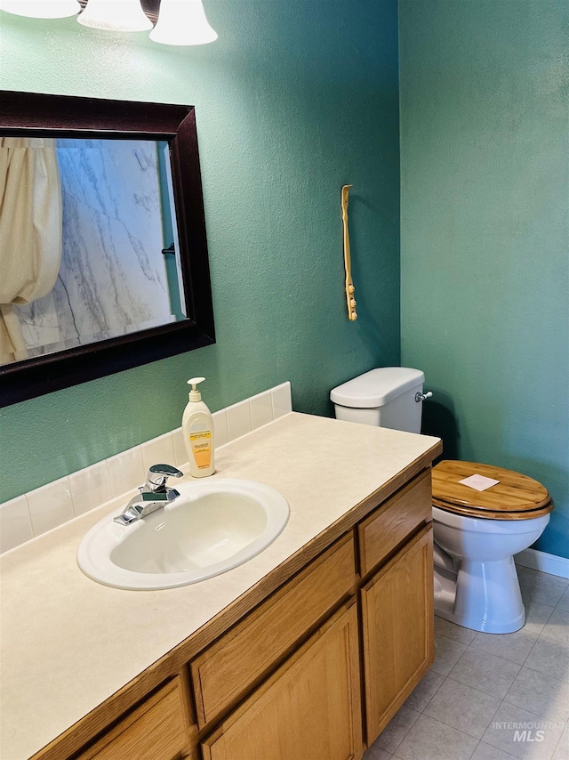 851 W Florida, Nampa, ID 83686 - bathroom with toilet, vanity, tile patterned floors, and baseboards