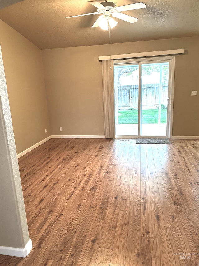 851 W Florida, Nampa, ID 83686 - spare room with wood finished floors, ceiling fan, baseboards, and a textured ceiling