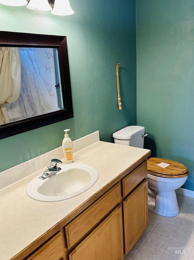 851 W Florida, Nampa, ID 83686 - bathroom with toilet, vanity, tile patterned floors, and baseboards
