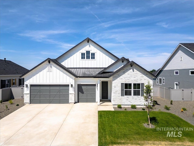 2158 N Kenora Ave, Star, ID 83669 - modern farmhouse style home featuring board and batten siding, an attached garage, a standing seam roof, driveway, and a gate