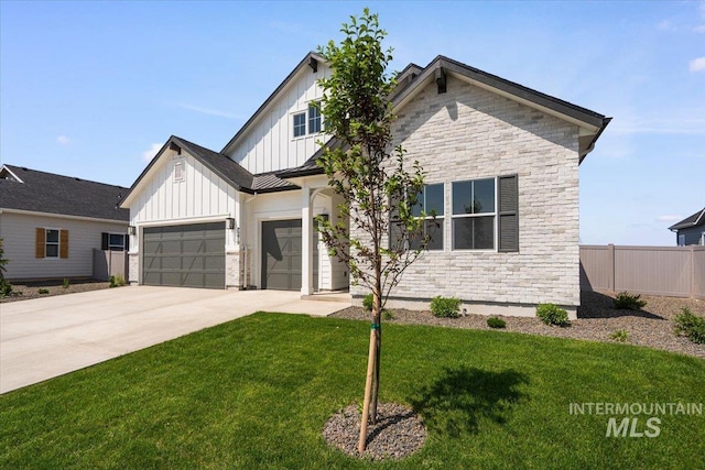 2158 N Kenora Ave, Star, ID 83669 - view of front of property with board and batten siding, stone siding, concrete driveway, a garage, and a standing seam roof