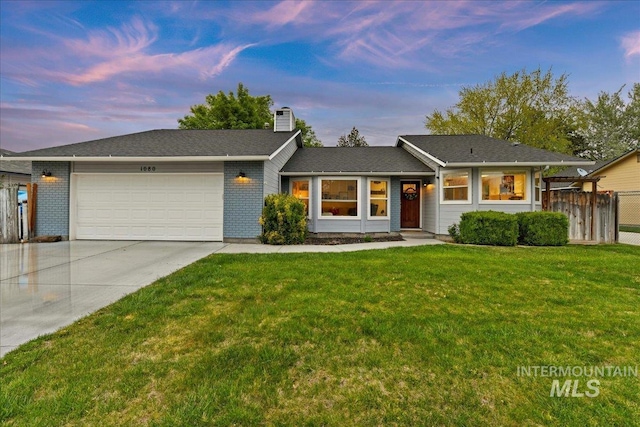 ranch-style house with a front lawn, fence, a chimney, an attached garage, and driveway