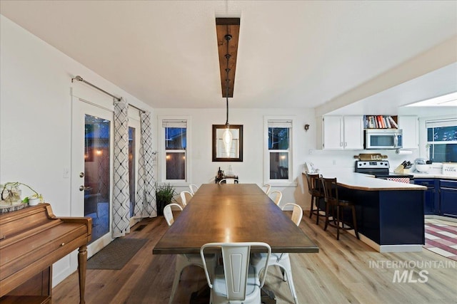 dining area featuring light wood-style flooring