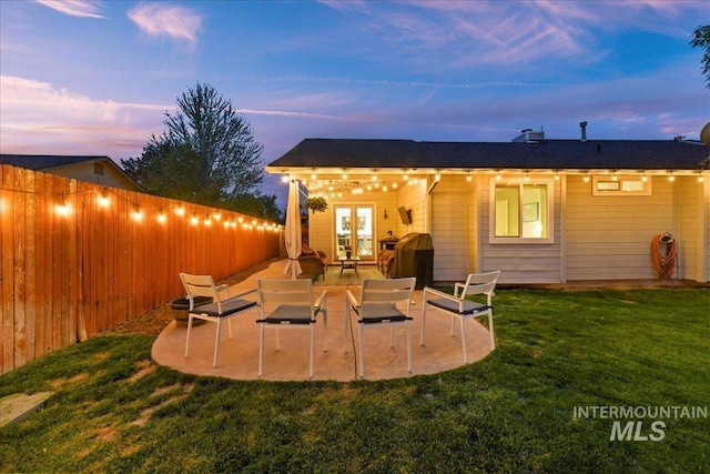 back of house with a lawn, a patio, french doors, and a fenced backyard