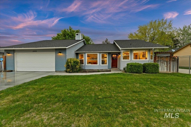 single story home featuring a garage, fence, a chimney, a lawn, and driveway