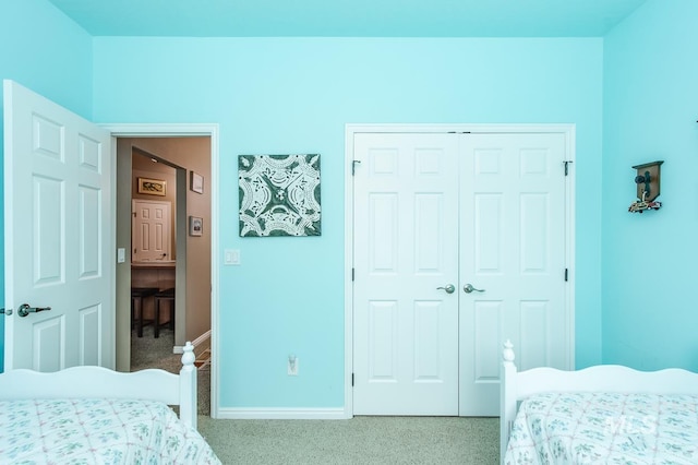 carpeted bedroom with a closet