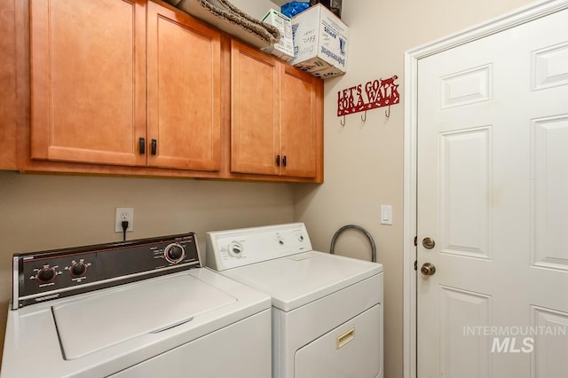 laundry area featuring cabinets and separate washer and dryer