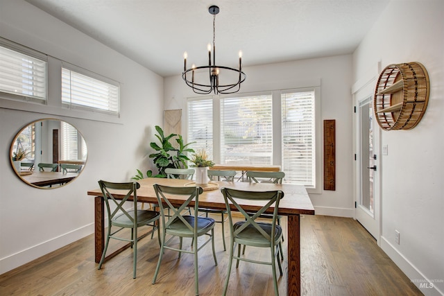 dining space featuring breakfast area, a chandelier, and wood-type flooring