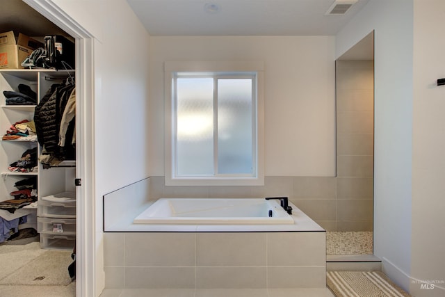 bathroom with tile patterned flooring and separate shower and tub