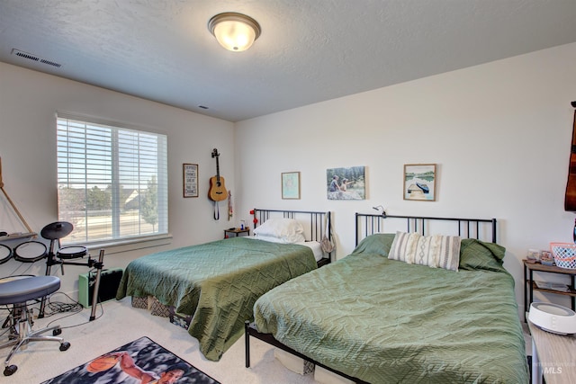 carpeted bedroom featuring a textured ceiling