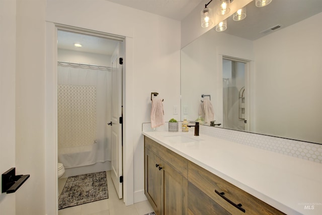 bathroom with tile patterned flooring, vanity, and toilet