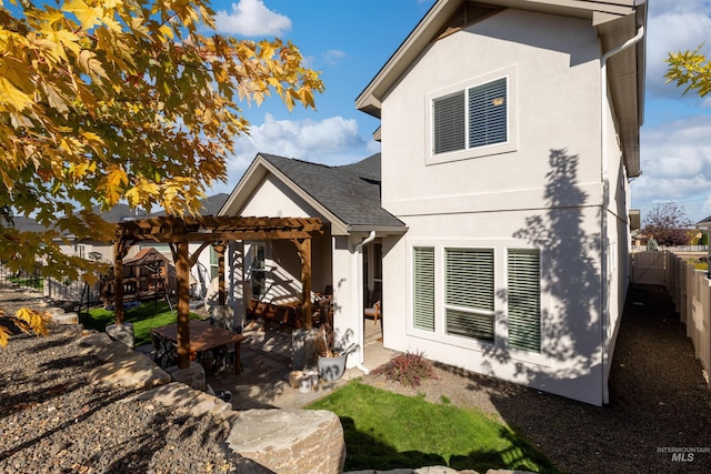 view of front of property featuring a patio area and a pergola