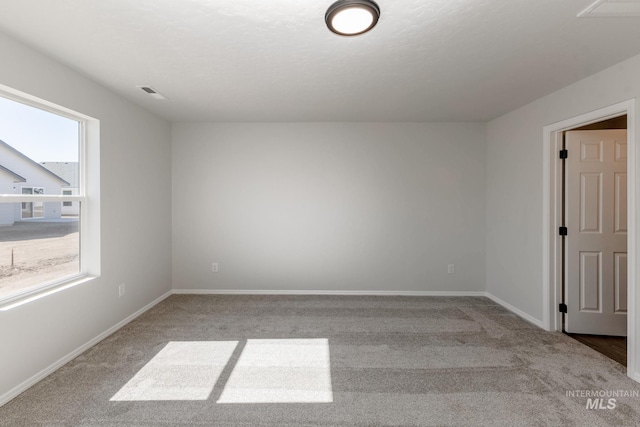 carpeted spare room with baseboards