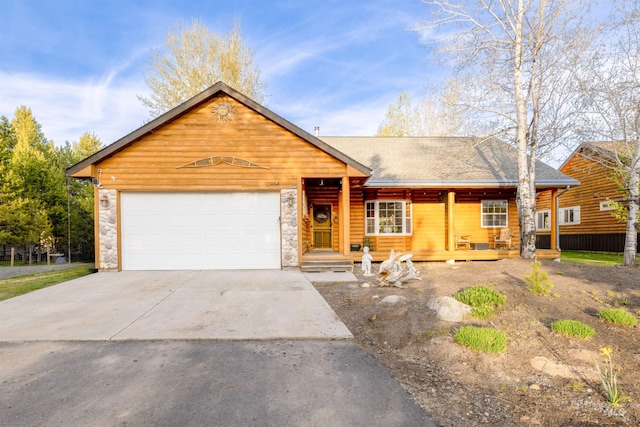 log home featuring a garage and covered porch