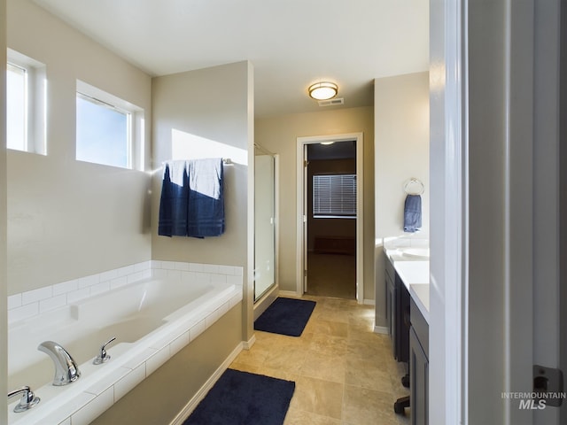 5122 Allentown St, Caldwell, ID 83605 - bathroom featuring a shower stall, a bath, vanity, and baseboards