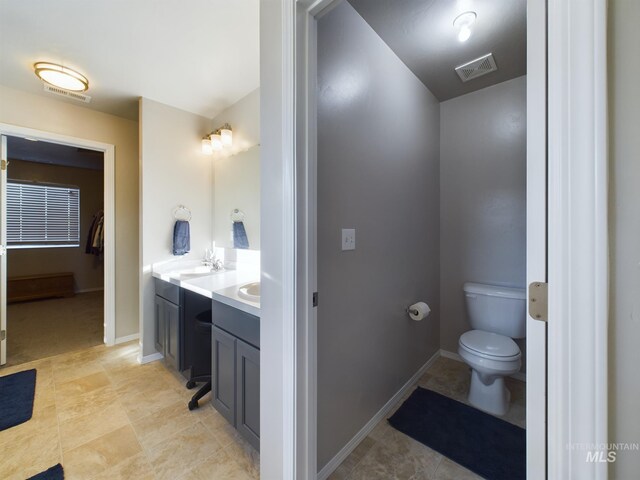 5122 Allentown St, Caldwell, ID 83605 - bathroom featuring toilet, vanity, tile patterned flooring, and baseboards
