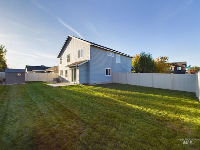 5122 Allentown St, Caldwell, ID 83605 - rear view of property featuring a storage unit, an outbuilding, and a patio