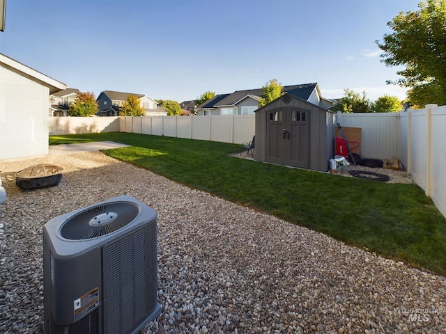 5122 Allentown St, Caldwell, ID 83605 - view of yard featuring central AC unit, an outdoor fire pit, a shed, an outbuilding, and a residential view