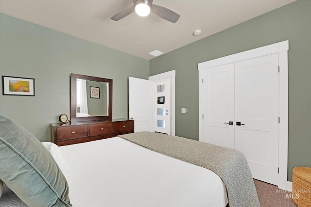 carpeted bedroom with a closet and a ceiling fan