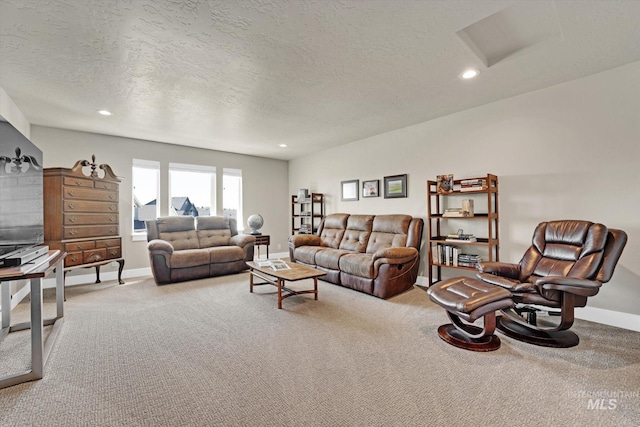 carpeted living area featuring attic access, baseboards, a textured ceiling, and recessed lighting